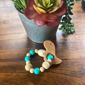 Dinosaur natural wood teether with teal food grade silicone